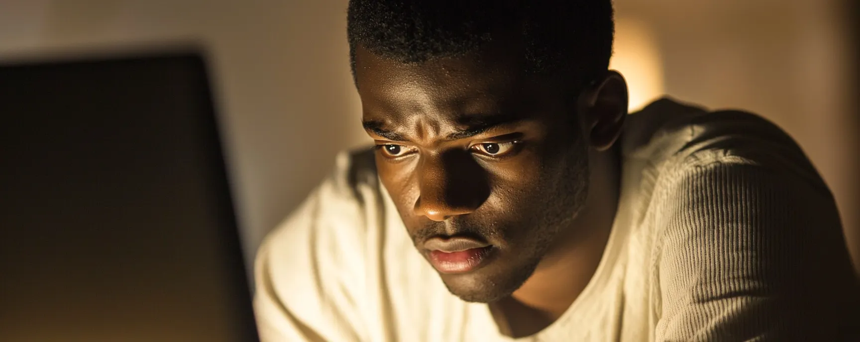 Overcoming porn addiction withdrawal symptoms: A man looking determined while using a computer, symbolizing the journey to recovery